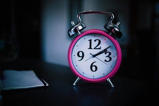 Close up of pink alarm clock.